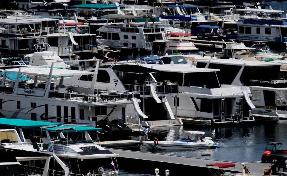 Boats at the Wahweap Marina are pushed toward the center of Lake Powell as the water continues to dramatically recede.