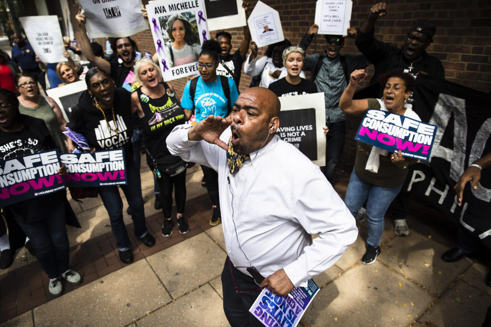 FILE - In this Sept. 5, 2019 file photo, Wilfredo Carrasquillo, center, and other protesters demonstrate in support of a proposed supervised injection site, outside the federal courthouse in Philadelphia. A federal appeals court became the latest panel to wrestle with the nation’s opioid epidemic as judges reviewed a plan Monday, Nov. 16, 2020, to open a medically supervised injection site in Philadelphia. (AP Photo/Matt Rourke, File)