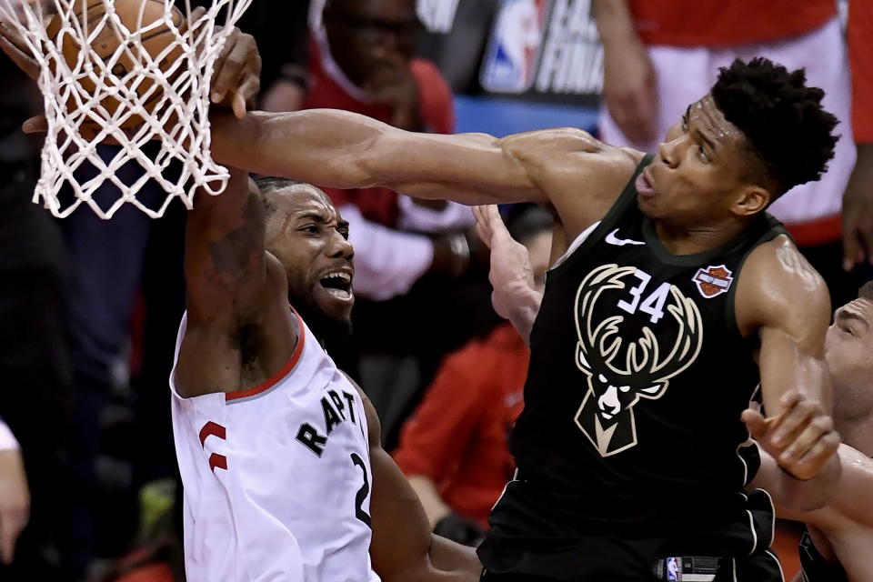 Milwaukee Bucks forward Giannis Antetokounmpo (34) blocks a dunk attempt by Toronto Raptors forward Kawhi Leonard (2) during the second half of Game 6 of the NBA basketball playoffs Eastern Conference finals Saturday, May 25, 2019, in Toronto. (Frank Gunn/The Canadian Press via AP)