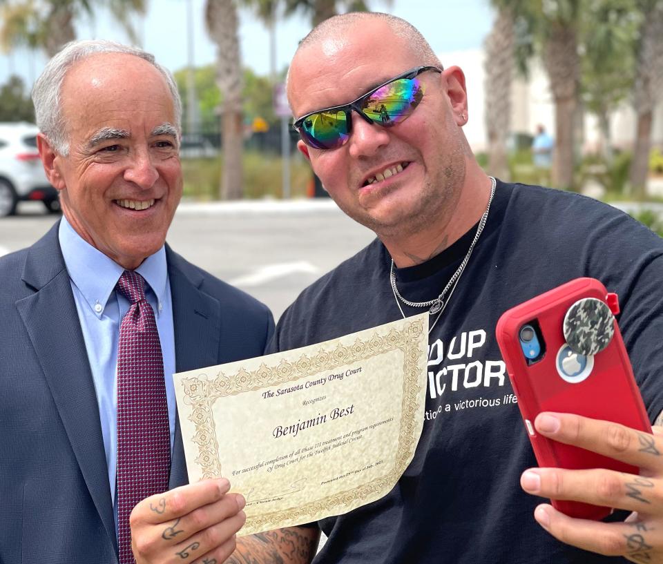 Benjamin Best of Bradenton, happened to see the Judge, Charles E. Roberts being photographed and stopped by to get a selfie with him and show him the progress he's been making after his arrest.