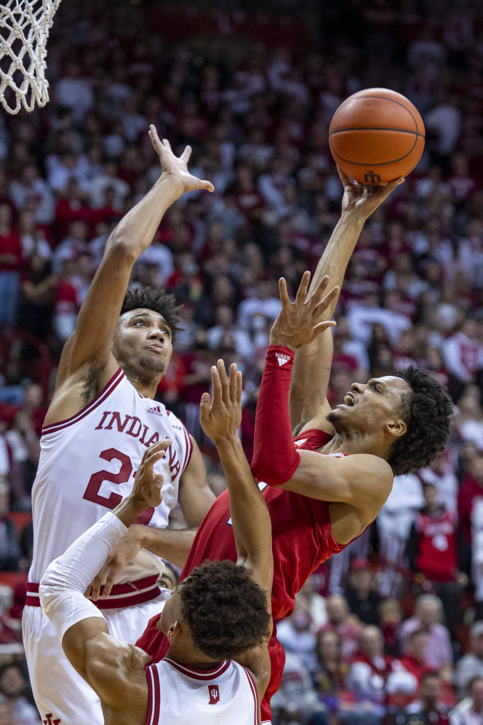 Indiana forward Trayce Jackson-Davis (23) attempts to block a shot by Nebraska guard Alonzo Verge Jr. (1) during the first half of a NCAA college basketball game, Saturday, Dec. 4, 2021, in Bloomington, Ind. (AP Photo/Doug McSchooler)