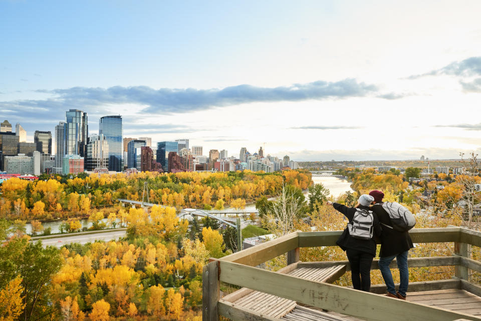 A couple overlooking the city of Calgary, Alberta (Getty Images)