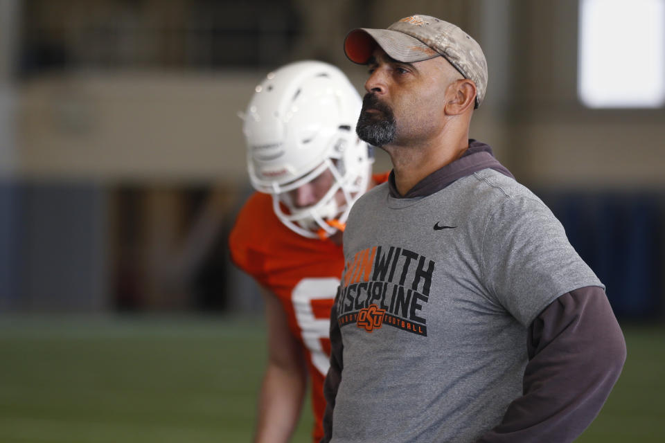 FILE - Oklahoma State's Kasey Dunn watches during an NCAA college football practice in Stillwater Okla., Tuesday, Aug. 6, 2019. It took Dunn almost 25 years to become an offensive coordinator, and he is now one of just seven Black coaches to hold that position at the 69 schools that play at the highest level of college football. (AP Photo/Sue Ogrocki, File)