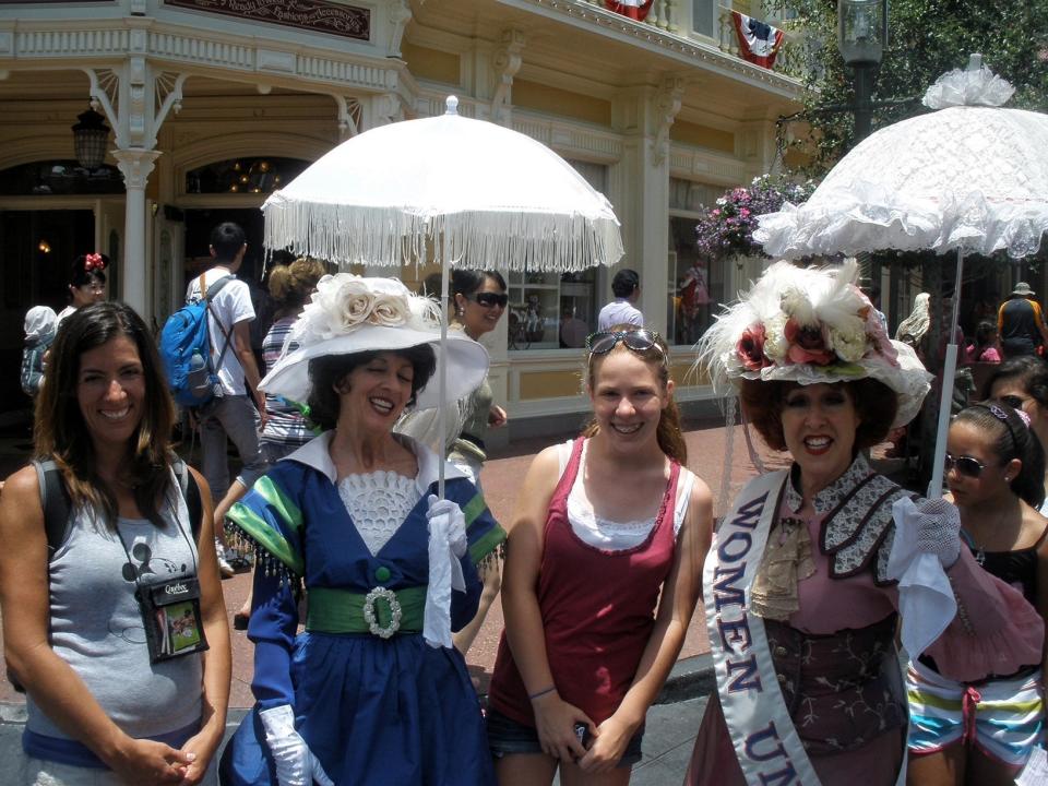 jackie posing with the suffragettes on main street in disney world