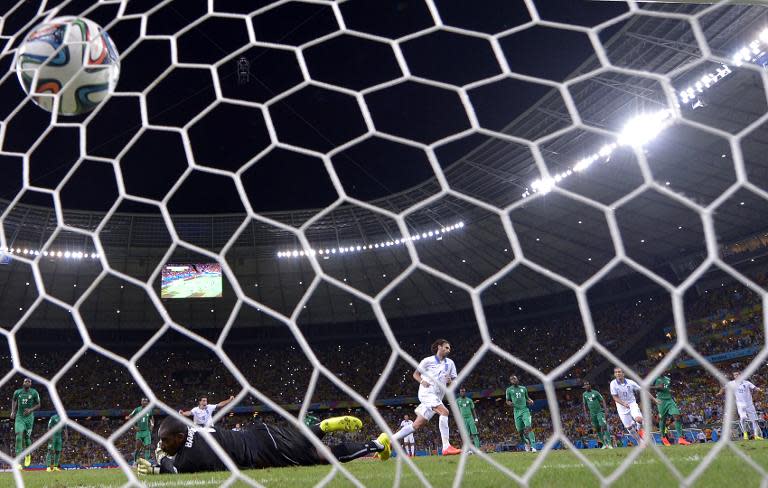 Ivory Coast's goalkeeper Boubacar Barry concedes a penalty to Greece's forward Georgios Samaras (back C) at the Castelao Stadium in Fortaleza during the 2014 FIFA World Cup on June 24, 2014