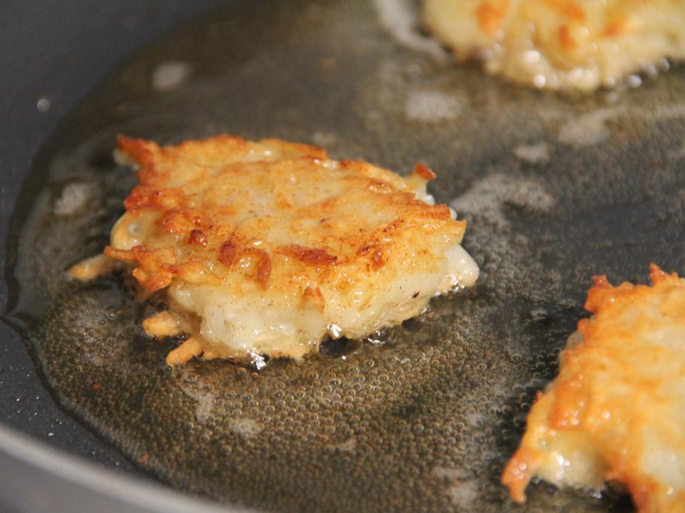 Latkes in a frying pan.