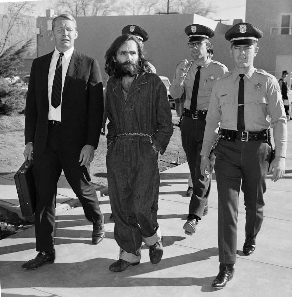 FILE - This Dec. 3, 1969, file photo shows Charles Manson en route to court in Independence, Calif., following his arrest at nearby Barker Ranch. Fifty years ago Charles Manson dispatched a group of disaffected young hippie followers on a two-night killing spree that terrorized Los Angeles and in the years since has come to represent the face of evil. On successive nights in August 1969, the so-called Manson family murdered seven people. (AP Photo/Harold Filan, File)