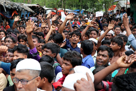 Rohingya refugees shout slogans as they take part in a protest at the Kutupalong refugee camp to mark the one year anniversary of their exodus in Cox's Bazar, Bangladesh August 25, 2018. REUTERS/Mohammad Ponir Hossain