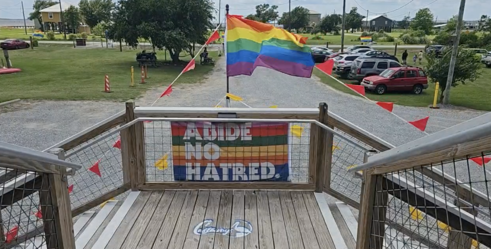 A Pride flag reads "Abide No Hatred" is hung at the entrance of Castaways, venue for the third annual SWLA Pride Fest weekend