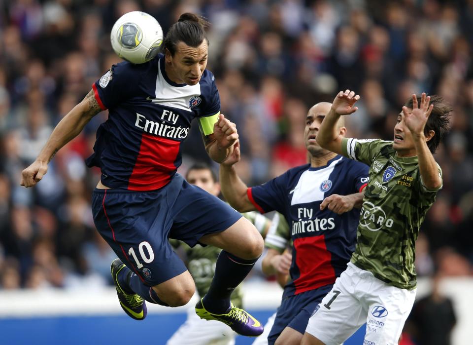 Paris St Germain's Zlatan Ibrahimovic challenges Bastia's Fethi Harek (R) and scores his second goal during their French Ligue 1 soccer match at the Parc des Princes Stadium in Paris October 19, 2013. REUTERS/Benoit Tessier (FRANCE - Tags: SPORT SOCCER)