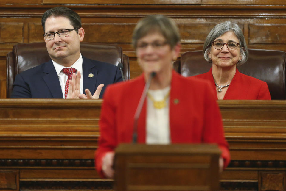 Kansas Speaker of the House Ron Ryckman, R-Olathe, left, and President of the Senate Susan Wagle, R-Wichita, right, listen as Gov. Laura Kelly gives her first State of the State address to lawmakers on the floor of the Kansas House on Wednesday, Jan. 16, 2019, in Topeka, Kan. (Chris Neal/The Topeka Capital-Journal via AP)