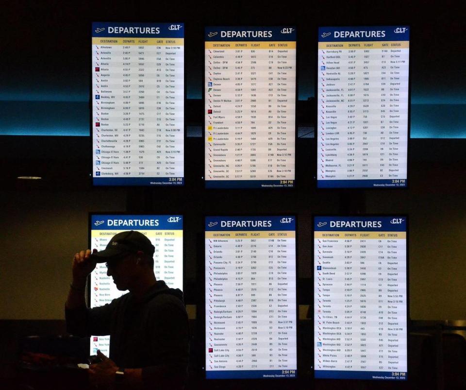 Finding your departure time for a connecting flight can sometimes be tricky. A passenger waits for his bags in the International area at Charlotte-Douglas International Airport on Wednesday, Dec.13, 2023.