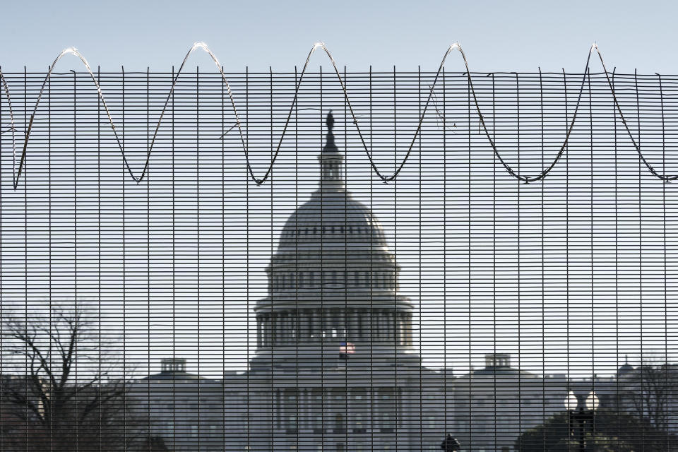 Fencing and razor wire surrounds the perimeter of the Capitol in Washington, Thursday, Feb. 25, 2021. (AP Photo/J. Scott Applewhite)