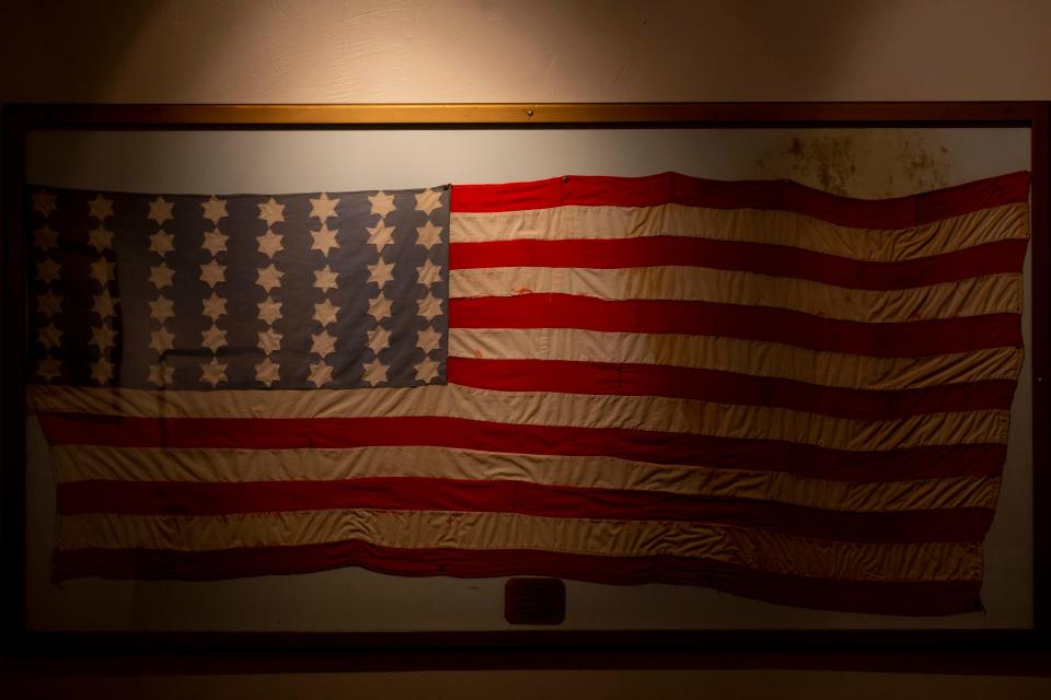 A flag stitched by Polish prisoners in 1945 at the Nordhausen Concentration Camp during World War II displays, Wednesday, June 8, 2022, in The John Ebling Veteran Art Gallery at American Legion Post No. 38 in Fort Myers, Fla.