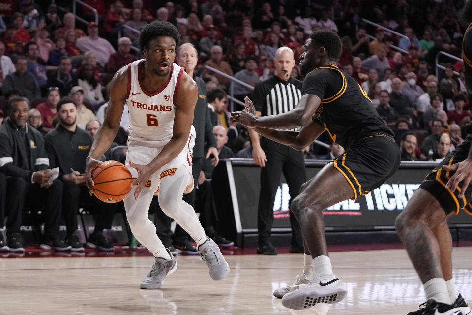 Southern California guard Bronny James, left, tries to get by Long Beach State guard Jadon Jones during the first half of an NCAA college basketball game Sunday, Dec. 10, 2023, in Los Angeles. (AP Photo/Mark J. Terrill)