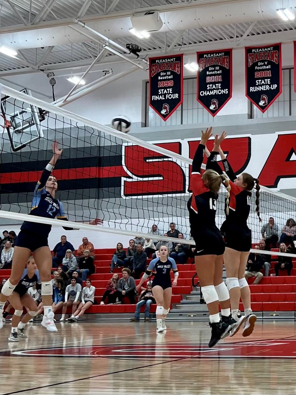 Pleasant's Lexi Olt and Kenzley Davis put up a block against the hitting of River Valley's Haleigh Creps during a Mid Ohio Athletic Conference volleyball match last week at Pleasant.