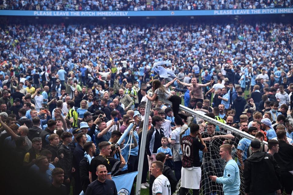 A large number of Manchester City fans entered the pitch after Pep Guardiola’s side secured the Premier League title  (AFP via Getty Images)