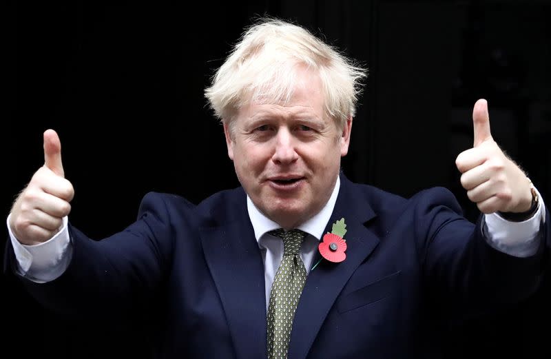 Britain's Prime Minister Boris Johnson meets fundraisers for the Royal British Legion outside Downing Street in London