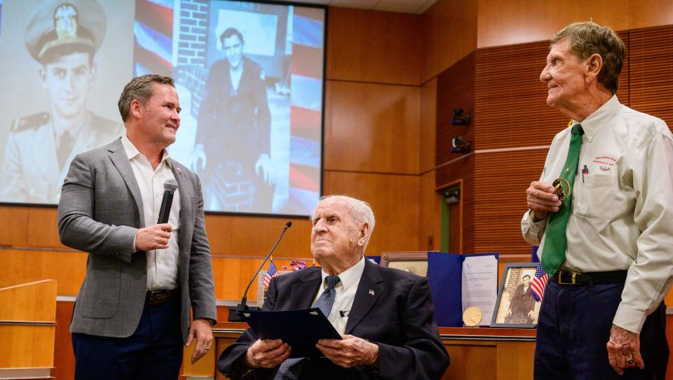 U.S. Rep. Mike Waltz speaks with Bill Pruitt, 102, and Ed Trester, 95, after presenting them each with a Congressional Gold Medal at a ceremony on Thursday, June 30, 2022, at the St. Johns County Administration building in St. Augustine.