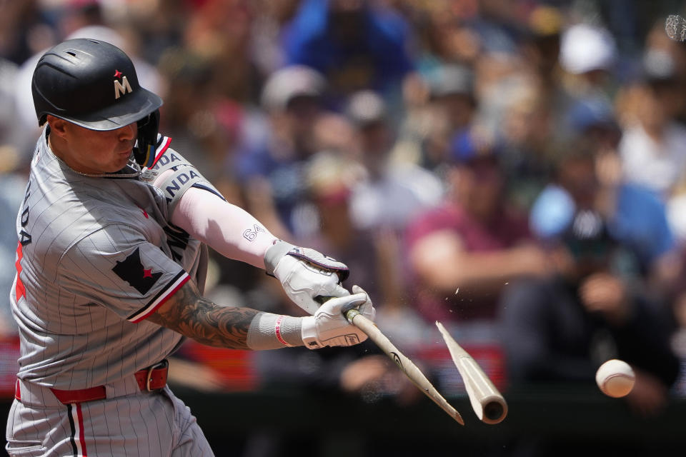 Minnesota Twins' Jose Miranda breaks his bat on an RBI single to score Austin Martin against the Seattle Mariners during the fifth inning of a baseball game Sunday, June 30, 2024, in Seattle. (AP Photo/Lindsey Wasson)