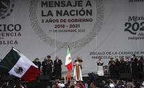 Mexican President Andres Manuel Lopez Obrador greets the crowd at a rally to commemorate his third anniversary in office, in the main square of the capital, the Zocalo, in Mexico City, Wednesday, Dec. 1, 2021. (Photo AP/Marco Ugarte)