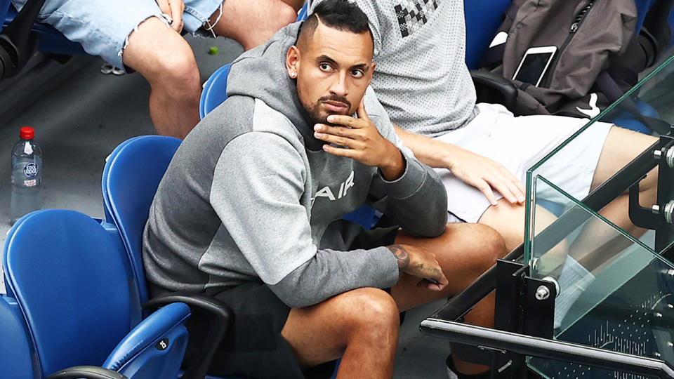 Nick Kyrgios, pictured here watching from the stands at the Australian Open.