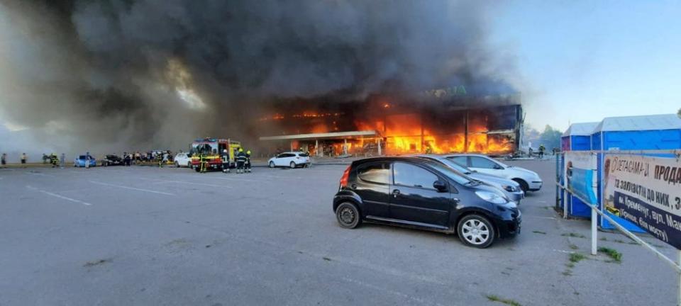 This handout picture taken and released by the Ukraine's State Emergency Service on June 27, 2022, shows firefighters putting out the fire in a mall hit by a Russian missile strike in the eastern Ukrainian city of Kremenchuk.