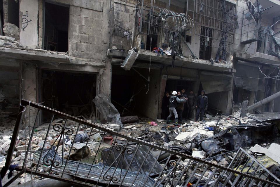 Residents look for survivors in a damaged site after what activists said was an air strike from forces loyal to Syria's President Bashar al-Assad in Takeek Al-Bab area of Aleppo