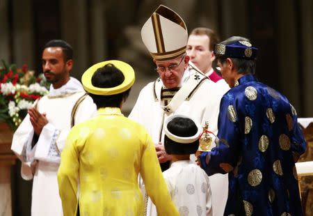 Pope Francis greets faithful as he leads the Christmas night Mass in Saint Peter's Basilica at the Vatican December 24, 2016. REUTERS/Tony Gentile