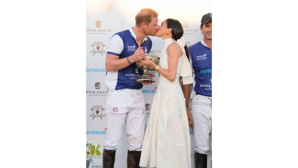 Prince Harry and wife Meghan Markle kiss as she presents his polo team with the trophy for winning the 2024 Royal Salute Polo Challenge to Benefit Sentebale