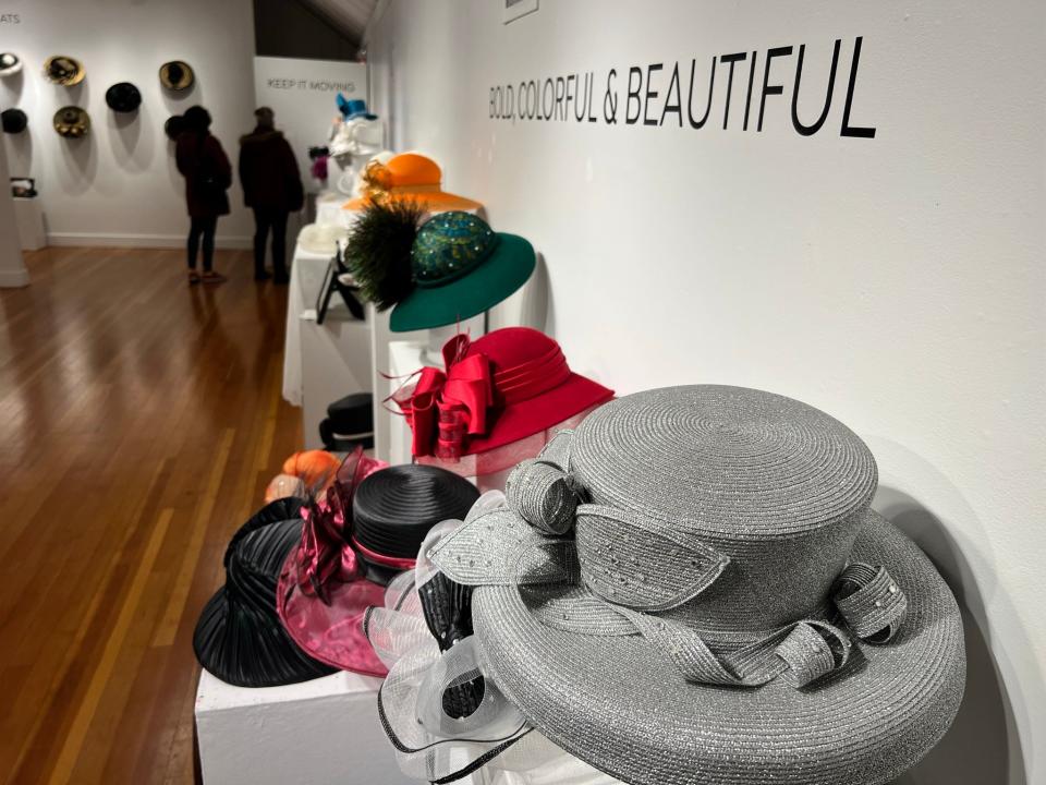 The exhibit "Hattitude: Hats from the Hatboxes of Willie Richardson"  at Bush Barn Art Center runs through Feb. 26, 2023. Words stamped on the walls, including 'Bold, colorful & beautiful' describe Richardson or some of her favorite thoughts.
