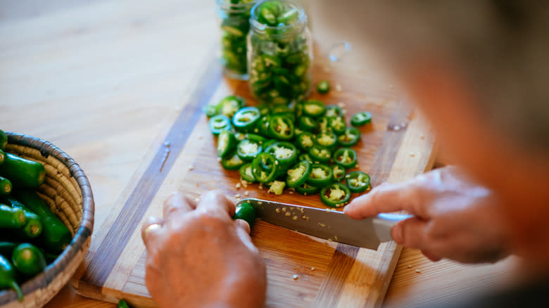 Person chopping jalapeños