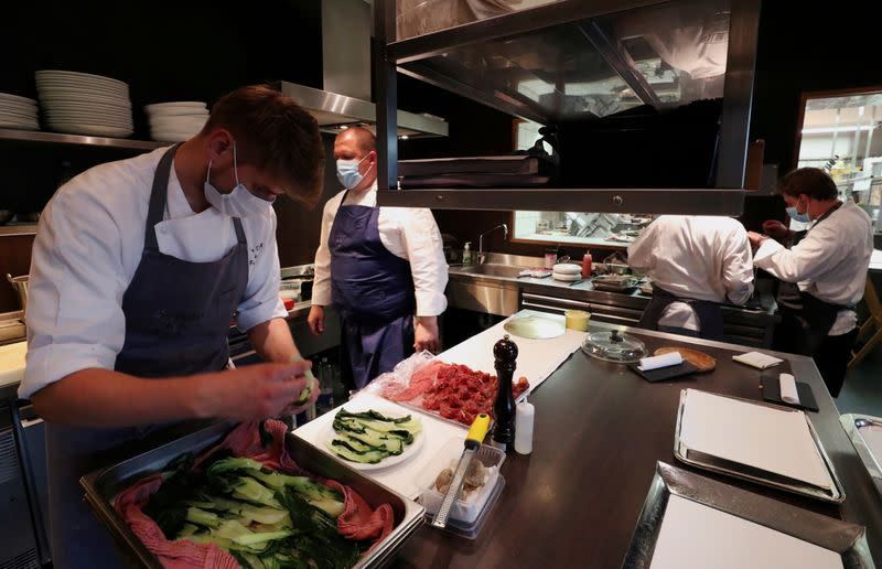 FILE PHOTO: Employees at the 2 stars Michelin restaurant Le Chalet de la Foret serve customers in Brussels