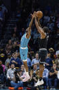 LA Clippers forward Kawhi Leonard shoots over Charlotte Hornets forward Jalen McDaniels to take the lead in the final seconds of the second half of an NBA basketball game on, Monday, Dec. 5, 2022, in Charlotte, N.C. (AP Photo/Scott Kinser)