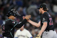 Arizona Diamondbacks catcher Gabriel Moreno greets relief pitcher Kevin Ginkel after Ginkel earned the save in a 3-2 win over the Seattle Mariners in a baseball game Sunday, April 28, 2024, in Seattle. (AP Photo/Lindsey Wasson)