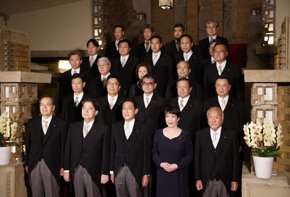 Japan's Prime Minister Fumio Kishida, front center, and his cabinet ministers pose for a photo at Kishida's residence, Wednesday, August 10, 2022, in Tokyo. (Issei Kato/Pool Photo via AP)