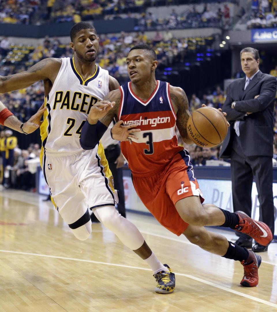 Washington Wizards guard Bradley Beal (3) drives on Indiana Pacers forward Paul George during the first half of game 2 of the Eastern Conference semifinal NBA basketball playoff series Wednesday, May 7, 2014, in Indianapolis. (AP Photo/Darron Cummings)