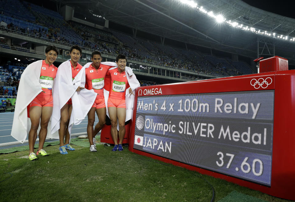 FILE - In this Aug. 19, 2016, file photo, Japan's Ryota Yamagata, Shota Iizuka, Yoshihide Kiryu and Aska Cambridge celebrate winning the silver medal in the men's 4 x 100-meter relay during the athletics competitions of the 2016 Summer Olympics at the Olympic stadium in Rio de Janeiro, Brazil.With the Tokyo Olympics less than two years away, Japanese athletes will be using the Asian Games to build confidence as they prepare to host the world on sport's biggest stage. (AP Photo/Matt Slocum, File)