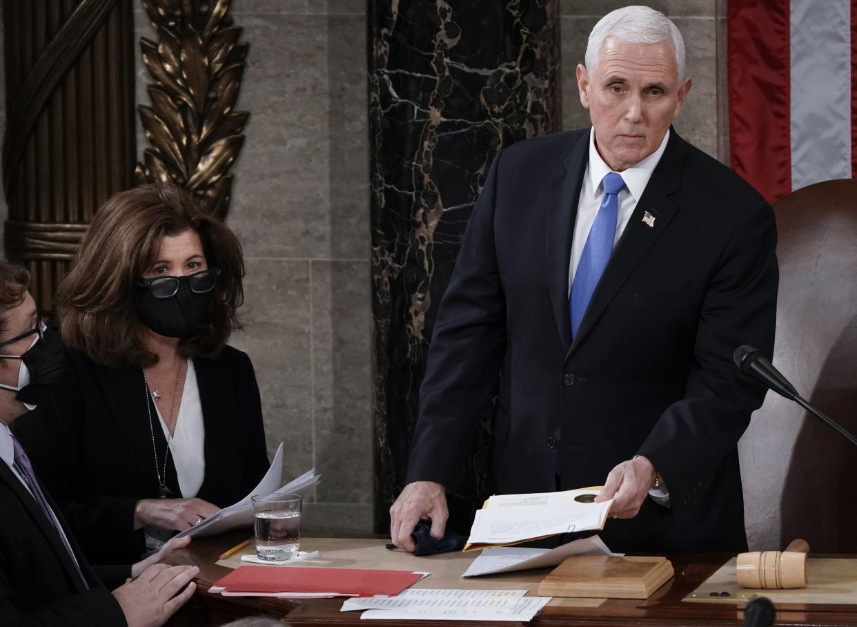 In this Jan. 6, 2021, file photo, Senate Parliamentarian Elizabeth MacDonough, second from left, works beside Vice President Mike Pence during the certification of Electoral College ballots in the presidential election, in the House chamber at the Capitol in Washington. Shortly afterward, the Capitol was stormed by rioters determined to disrupt the certification.