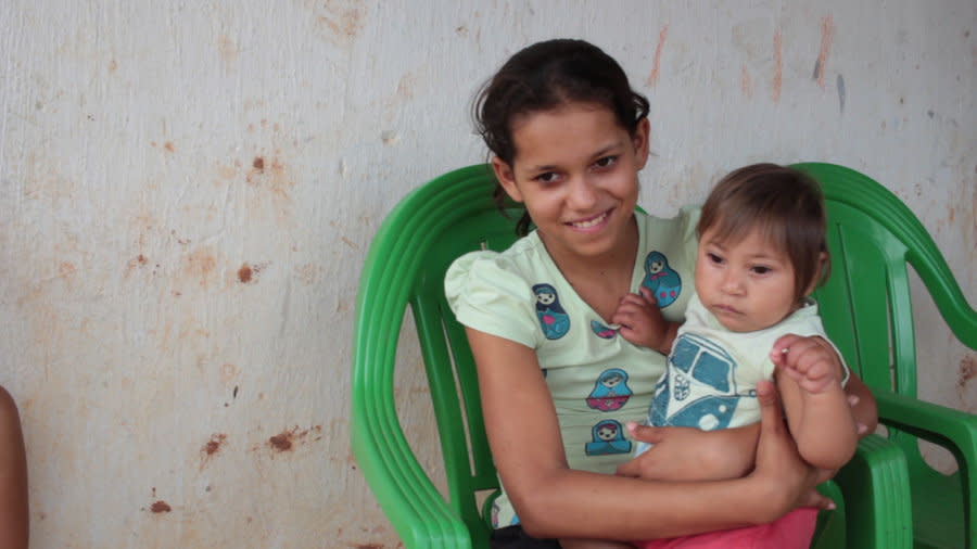 De Barros&rsquo; son Miguel was born with microcephaly. Here, the baby is held by de Barros&rsquo; daughter Juliana, age 12. (Photo: Jul Sousa for HuffPost)