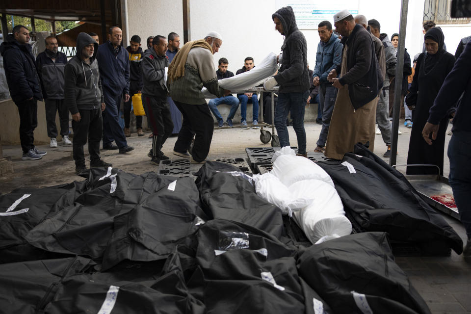 Palestinians mourn relatives killed in the Israeli bombardment of the Gaza Strip at a hospital morgue in Rafah, Tuesday, March 26, 2024. (AP Photo/Fatima Shbair)