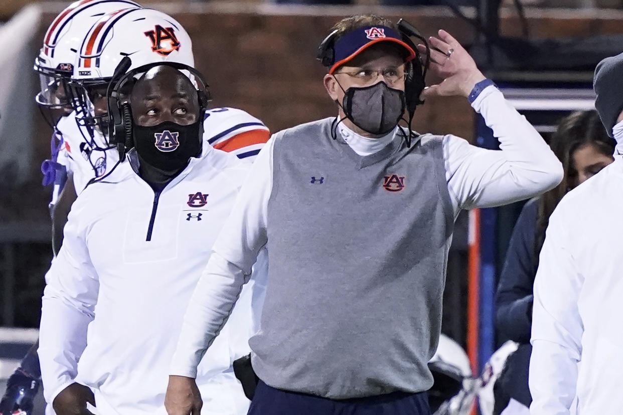 Auburn head coach Gus Malzahn listens to an official's call during a game against Mississippi State on Dec. 12. (AP)