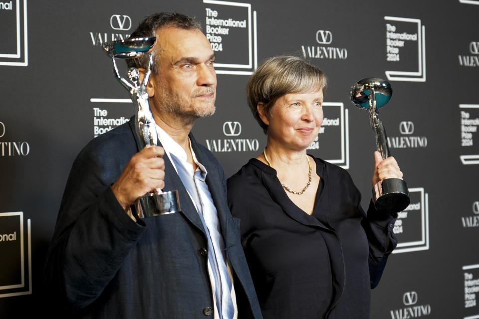 Jenny Erpenbeck, author of 'Kairos', right, and translator Michael Hofmann pose with the trophy after winning the International Booker Prize, in London, Tuesday, May 21, 2024. (AP Photo/Alberto Pezzali)