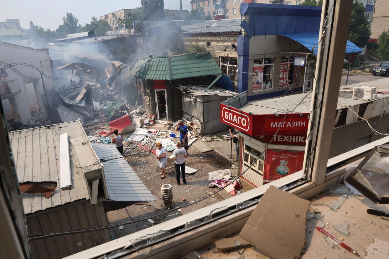 People look over the wreckage after a missile stuck a shopping mall on July 03, 2022 in Sloviansk, Ukraine. The attack was one of many in the city early Sunday afternoon.