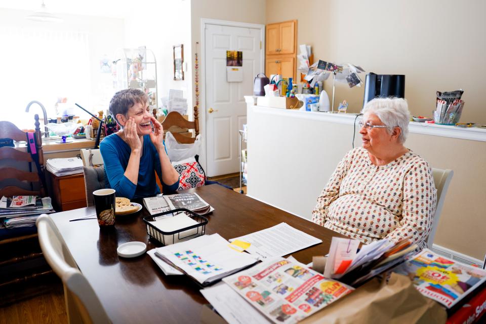 Marlene Mears, left, and Becky Miller, right, chat at their kitchen table in Longmont, Colo. Mears has been a tenant at Miller's home for over two years.