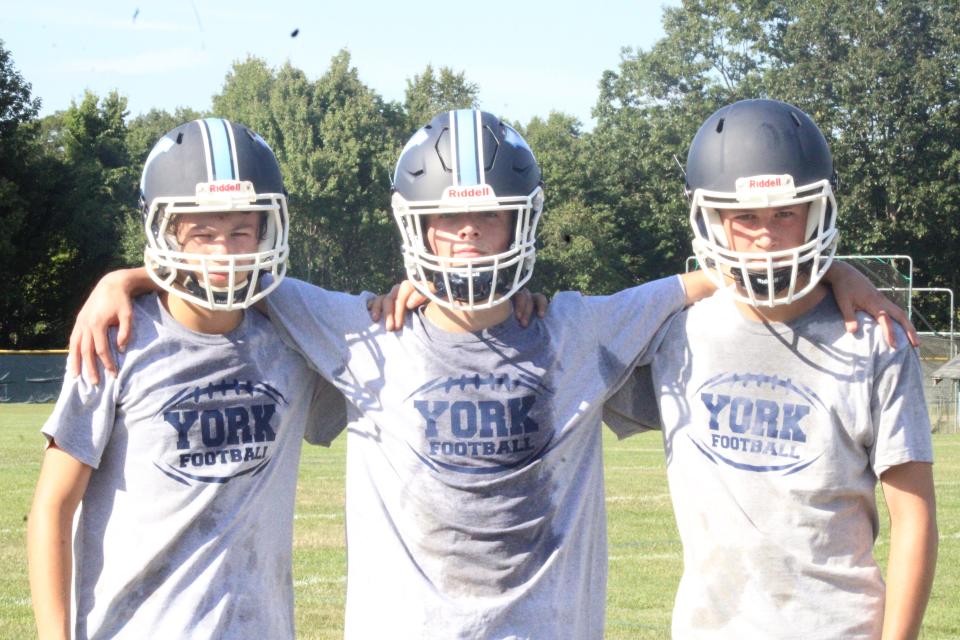 From left, York High School sophomore Alex Taylor, junior Gavin Davis and sophomore Pete Martin are battling for the starting quarterback for the Wildcats this upcoming season.