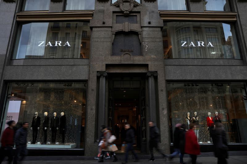 FILE PHOTO: People walk past a Zara store, an Inditex brand, in central Madrid