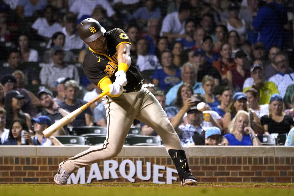 San Diego Padres' Luke Voit swings for a three-run double off Chicago Cubs relief pitcher Mychal Givens during the seventh inning of a baseball game Tuesday, June 14, 2022, in Chicago. (AP Photo/Charles Rex Arbogast)