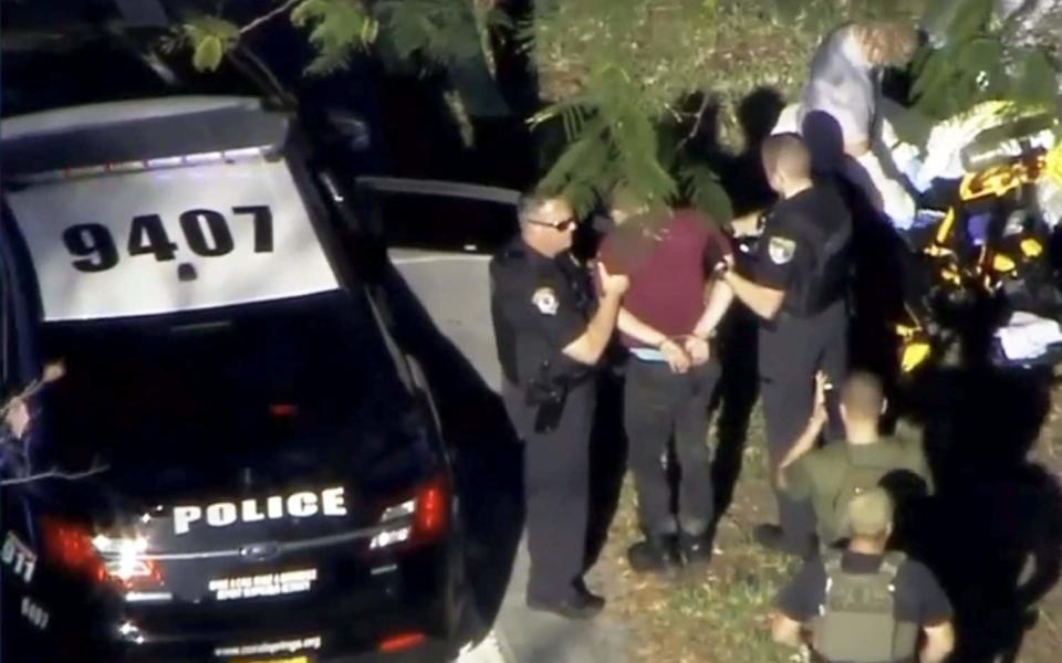 Shooting suspect Nikolas Cruz is hauled away by police in Florida minutes after the shooting. (WSVN 7 News)