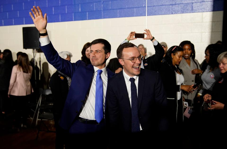 Chasten and Pete Buttigieg wave to supporters at an election night rally in Des Moines, Iowa, U.S., February 3, 2020. REUTERS/Eric Thayer